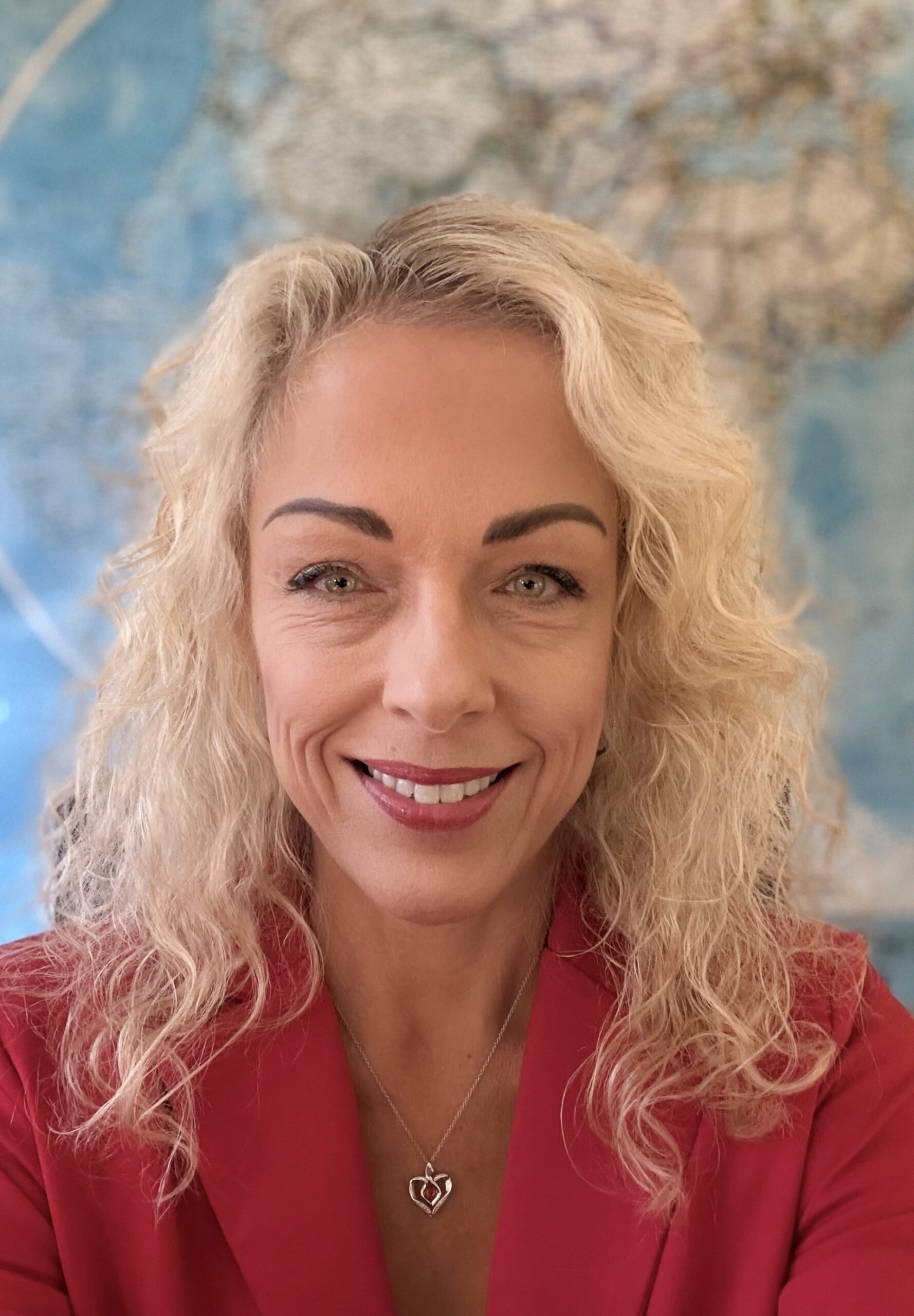 Woman with Blond hair and red suit. 